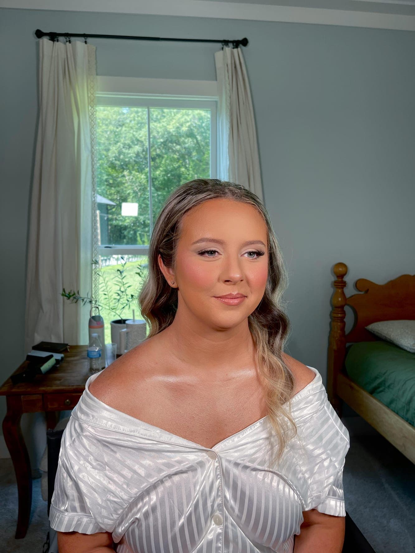 Bride in soft glam on the wedding morning, finished and getting ready